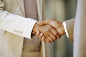close-up of a businessman shaking hands with a businesswoman